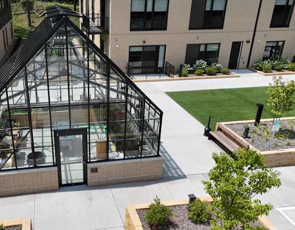 an aerial view of a greenhouse on the side of a building