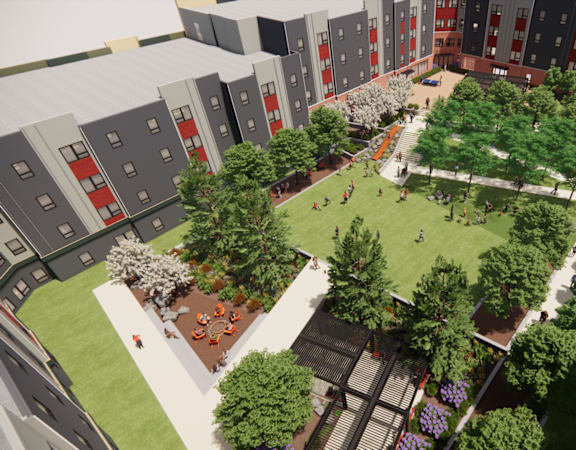 A courtyard surrounded by buildings with people walking and sitting.