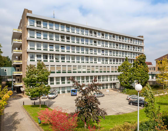 A large building with a parking lot in front of it.