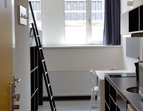 A kitchen with a microwave oven on the counter.