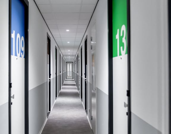 A long hallway with doors 109 and 13 on the side.