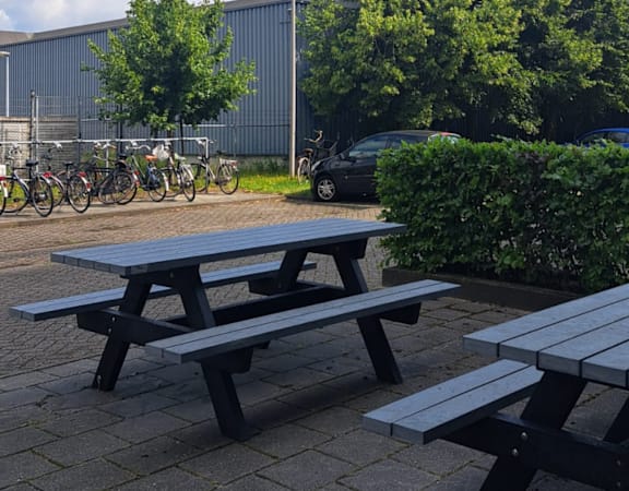 A picnic table is in the foreground of a park.