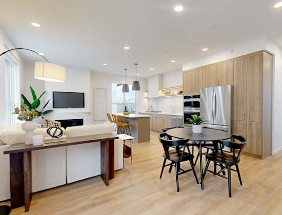 A modern kitchen with a dining table and chairs.