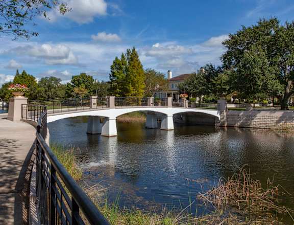 A bridge over a river with a walkway on the left side.