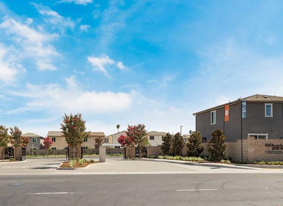 A sunny day at a residential complex with a clear blue sky.