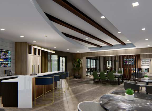 A modern interior space with a bar, seating, and a television.