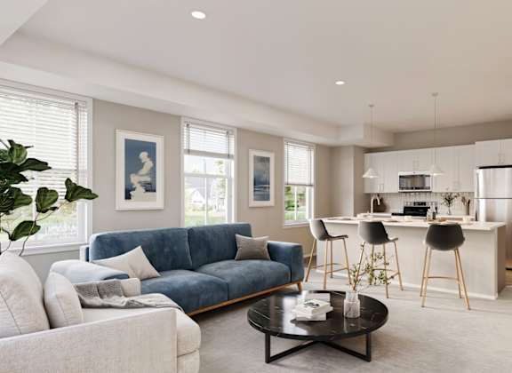 A modern living room with a blue sofa and a coffee table.