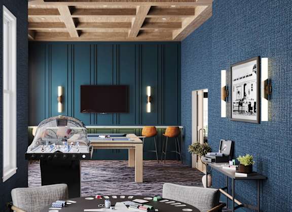 A room with a pool table and a television.