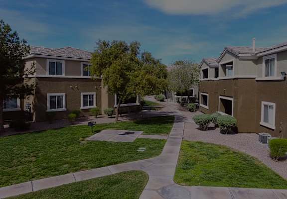 a city street with houses on either side of a sidewalk  at Silver Creek Apartments, Las Vegas, NV