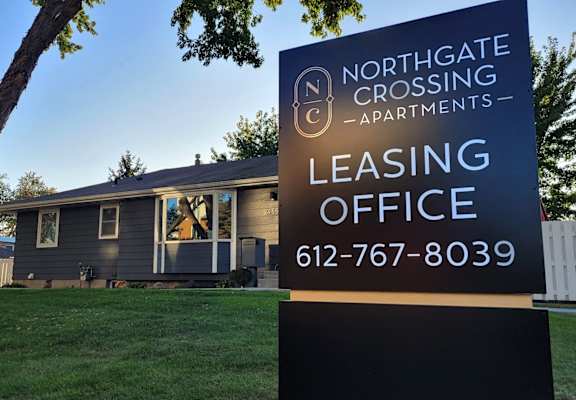 a selling office sign in front of a house