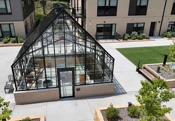an aerial view of a greenhouse on the side of a building