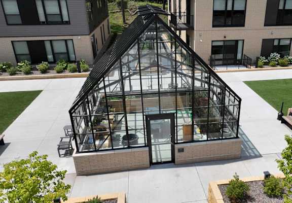 an aerial view of a greenhouse on the side of a building