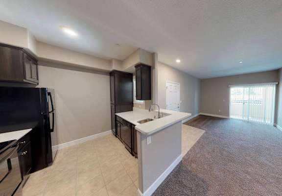 A kitchen with black appliances and a countertop.at Edgewater, Pittsburg, CA