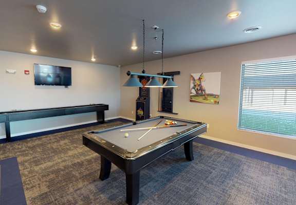 a games room with a pool table and a television at Upscale Living at the Grand off 45th, Fargo, 58104