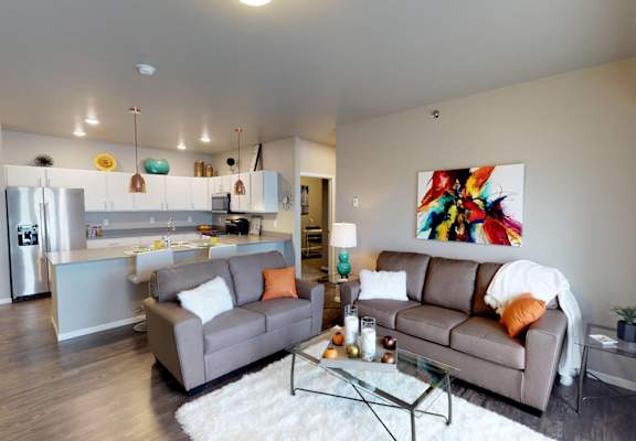 a living room with two couches and a glass table at Upscale Living at the Grand off 45th, Fargo, 58104