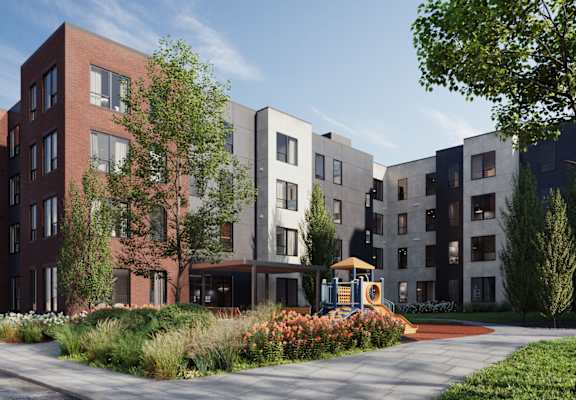 A modern apartment complex with a playground in the foreground.