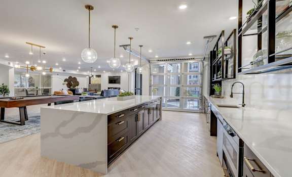 A modern kitchen with a central island and a dining area.