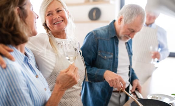 a group of people cooking in a kitchen