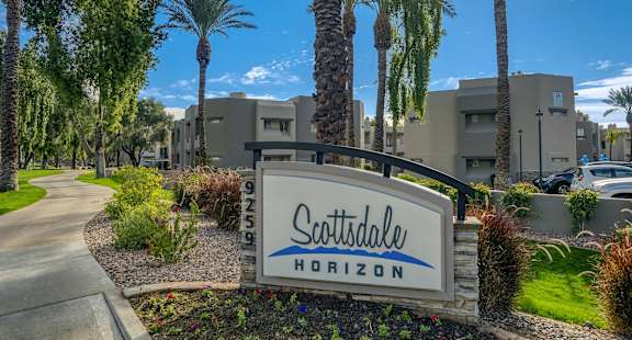 the sign at the entrance of scottsdale hotel on a tree lined street