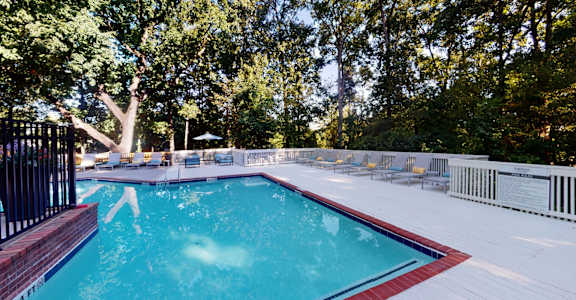 Sparkling pool with expansive sundeck and chaise lounges at Summerchase at Riverchase in Hoover, AL