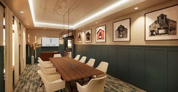 a conference room with a wooden table and chairs and pictures on the wall
