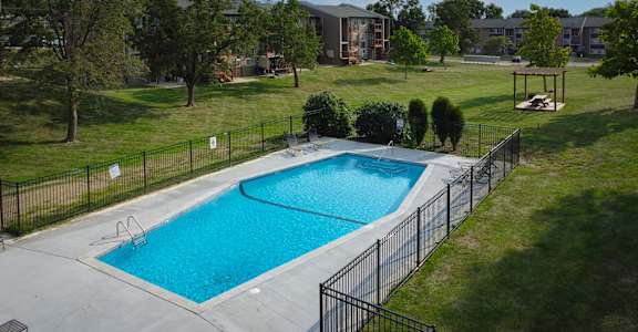 A small pool surrounded by a black fence.