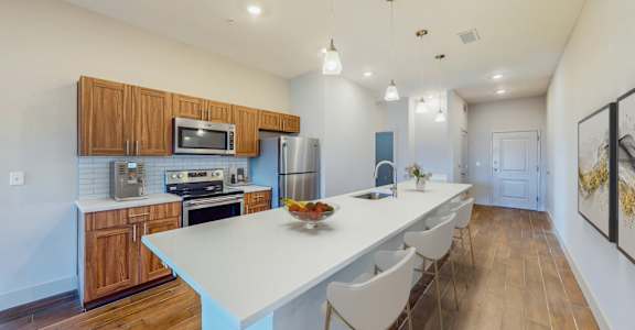 A kitchen with a white table and chairs.