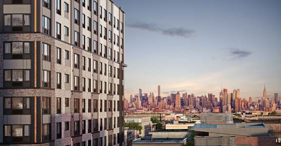 a view of the nyc skyline from a high rise building