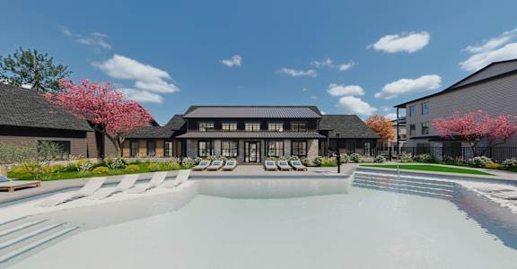 A modern building with a pool in front and trees with pink flowers on the left.