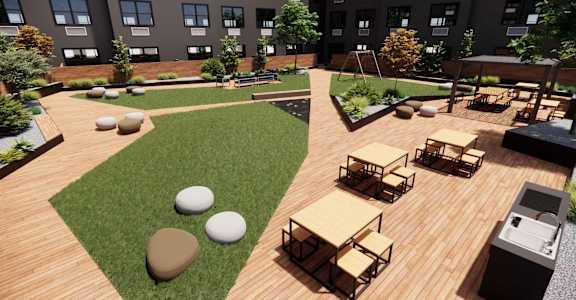 A modern outdoor seating area with wooden tables and benches.