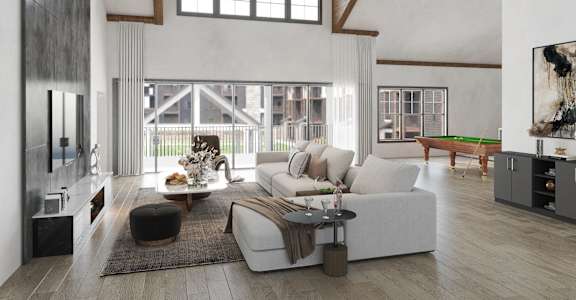 a living room with a couch and a table in front of a large window