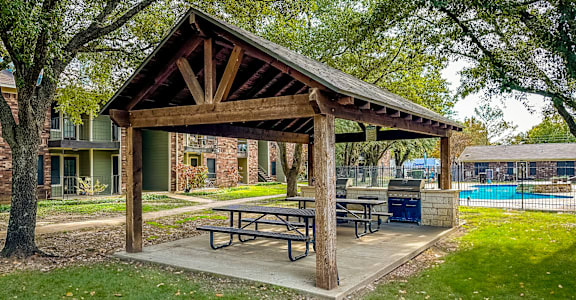 a picnic area with a picnic table in a park