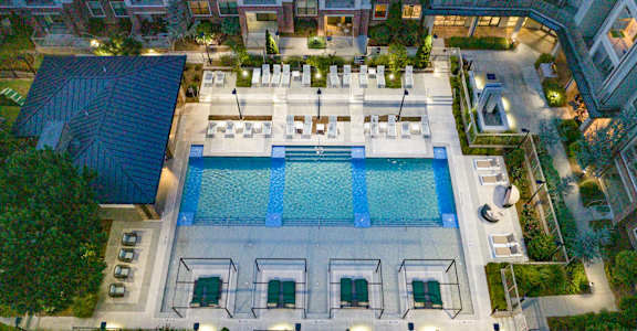 an aerial view of resort style pool at night at The Hendrix, Atlanta, GA, 30329