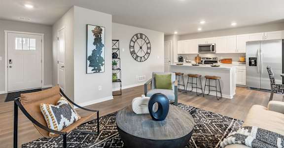A modern living room with a large coffee table and a bar area.