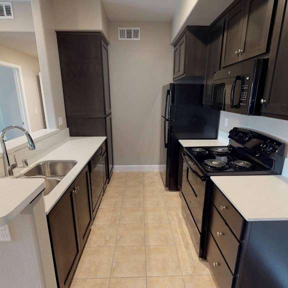 A kitchen with a refrigerator, microwave, and oven.at Edgewater, Pittsburg, CA 94565