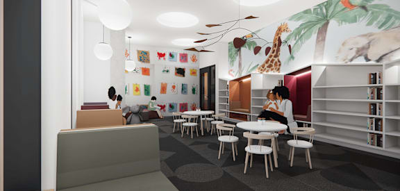 A room with a mural of a giraffe and a tree on the wall.
