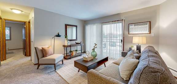 a living room with a couch chair and coffee table