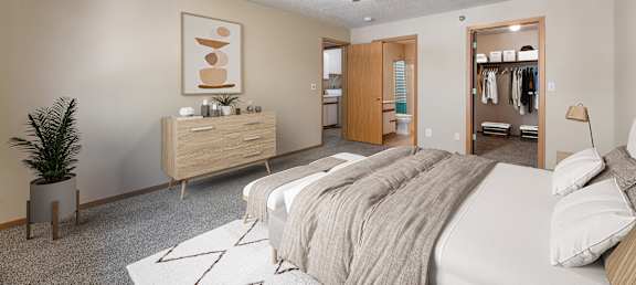 a bedroom with a large bed and a ceiling fan