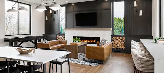 a living room with a fireplace and a table and chairs