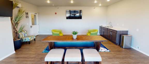 a dining room with a table and chairs and a tv at Upscale Living at the Grand off 45th, Fargo, 58104