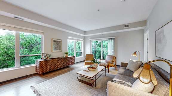 A living room with a couch, chair, and table.