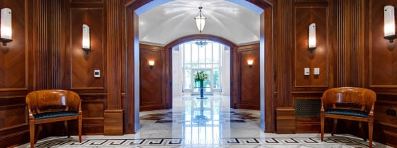 a view of the marble floors and wood paneled walls in the lobby
