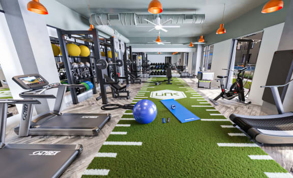 a spacious fitness room with treadmills and other exercise equipment