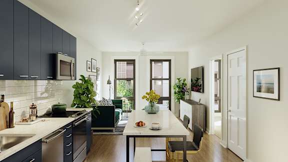 A modern kitchen with dark blue cabinets and a white countertop.