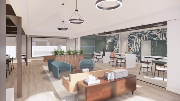 A modern office space with a reception desk and seating area.