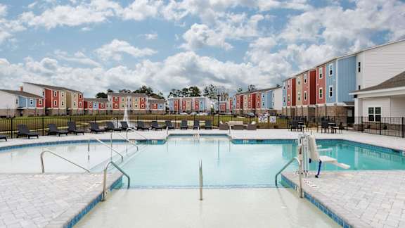 a swimming pool is shown in front of an apartment building