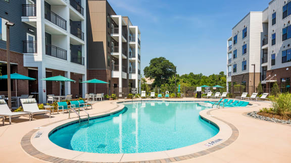 a swimming pool in front of an apartment building