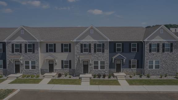 A row of houses with grey stone exteriors.