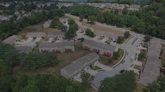 A bird's eye view of a residential area with houses and trees.