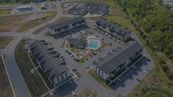 A bird's eye view of a residential complex with a swimming pool.